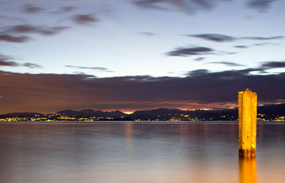 Scenic view of lake against sky at dusk