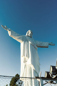 Low angle view of statue against clear blue sky