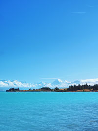 Scenic view of sea against blue sky