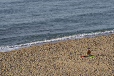 High angle view of woman relaxing on beach