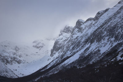 Scenic view of snow covered mountains against sky