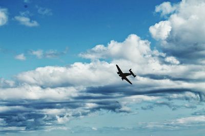 Low angle view of airplane flying in sky