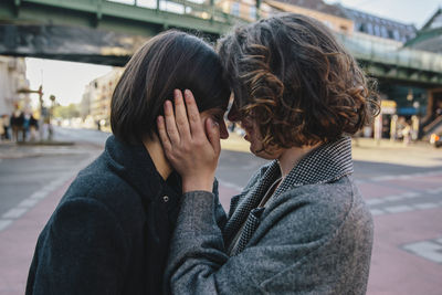 Young woman face to face with lesbian partner in city