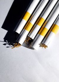 High angle view of colored pencils over white background