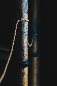 Close-up of rope tied to metal pipe