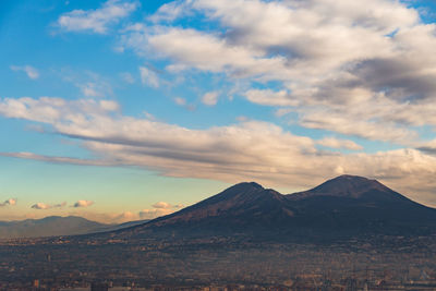 Scenic view of snowcapped mountain against cloudy sky