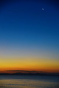 Scenic view of sea against clear sky at sunset