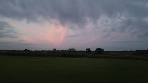 Scenic view of field against sky during sunset