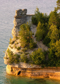 Two swimmers at the base of miners castle in unusually calm lake superior waters.