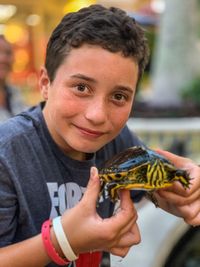 Portrait of boy holding camera