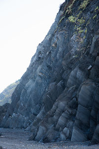 Low angle view of rock formation against sky