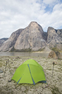 Tent pitched at rock climbers camp below stunning granite mountains.