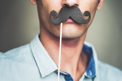 Close-up of man with mustache prop