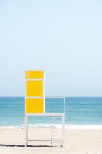 Lifeguard hut on beach against clear sky