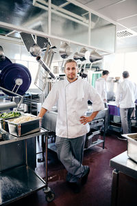 Portrait of confident male chef standing in commercial kitchen