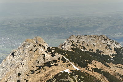 Scenic view of mountain by sea against sky