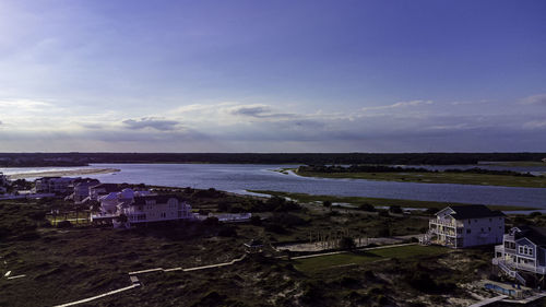 High angle view of townscape by sea against sky