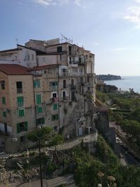 High angle view of buildings by sea against sky