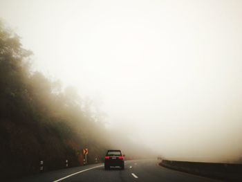 Cars on road against sky