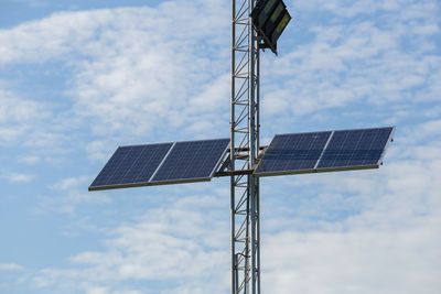 Low angle view of communications tower against sky