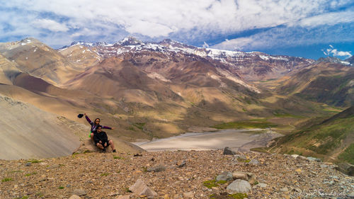 People on mountains against sky