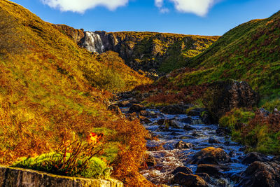 Scenic view of waterfall against sky during autumn