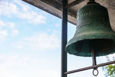 Low angle view of electric lamp against sky