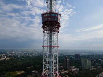 Communications tower and buildings against sky