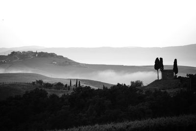 Woman standing on mountain against sky