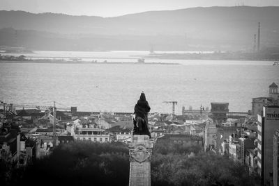 Man standing on bridge over water