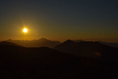 Scenic view of silhouette mountains against sky during sunset