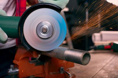 Close-up of man working on metal