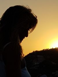 Portrait of woman looking at sunset