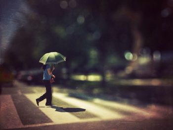 Woman walking on umbrella