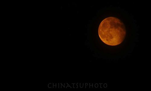 Low angle view of moon in the dark