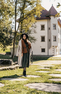 Young woman standing in park, wearing autumn clothes, style, stylish, fashion.