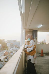 Woman standing on bridge against sky