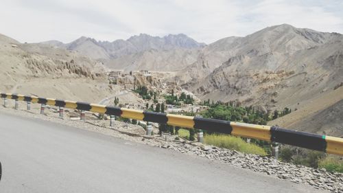 Scenic view of road and mountains against sky