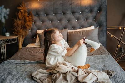 Little girl playing on the bed. high quality photo