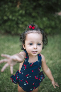 Portrait of cute girl on field