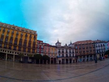 Buildings in town against sky