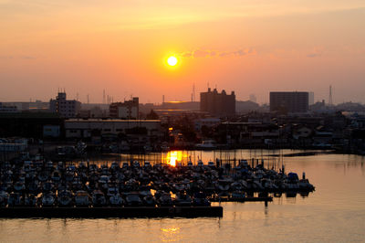 High angle view of illuminated city at sunset