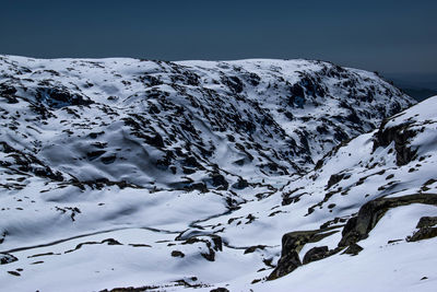 Snow covered mountains against clear sky