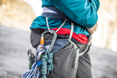 Midsection of man holding rope