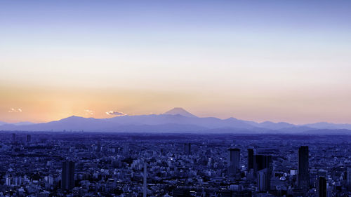 Cityscape against sky during sunset