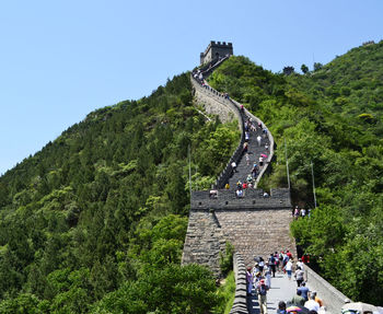 High angle view of people on mountain against sky