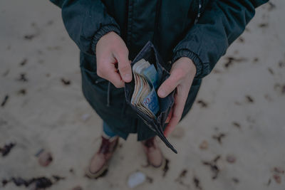 Paper money in a wallet, holds in hands, savings for holidays, cash paper money for calculation