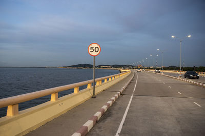 Road by sea against sky