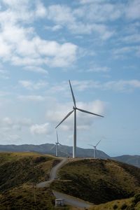Windmill on field against sky