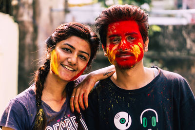 Portrait of young couple standing outdoors